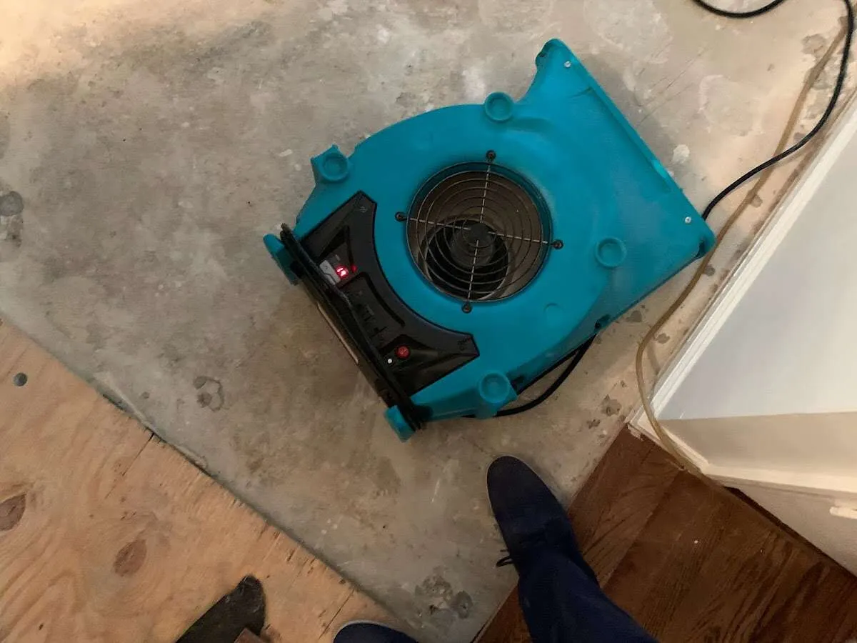 Air mover drying subfloor during Leak Detection & Repair in Amity